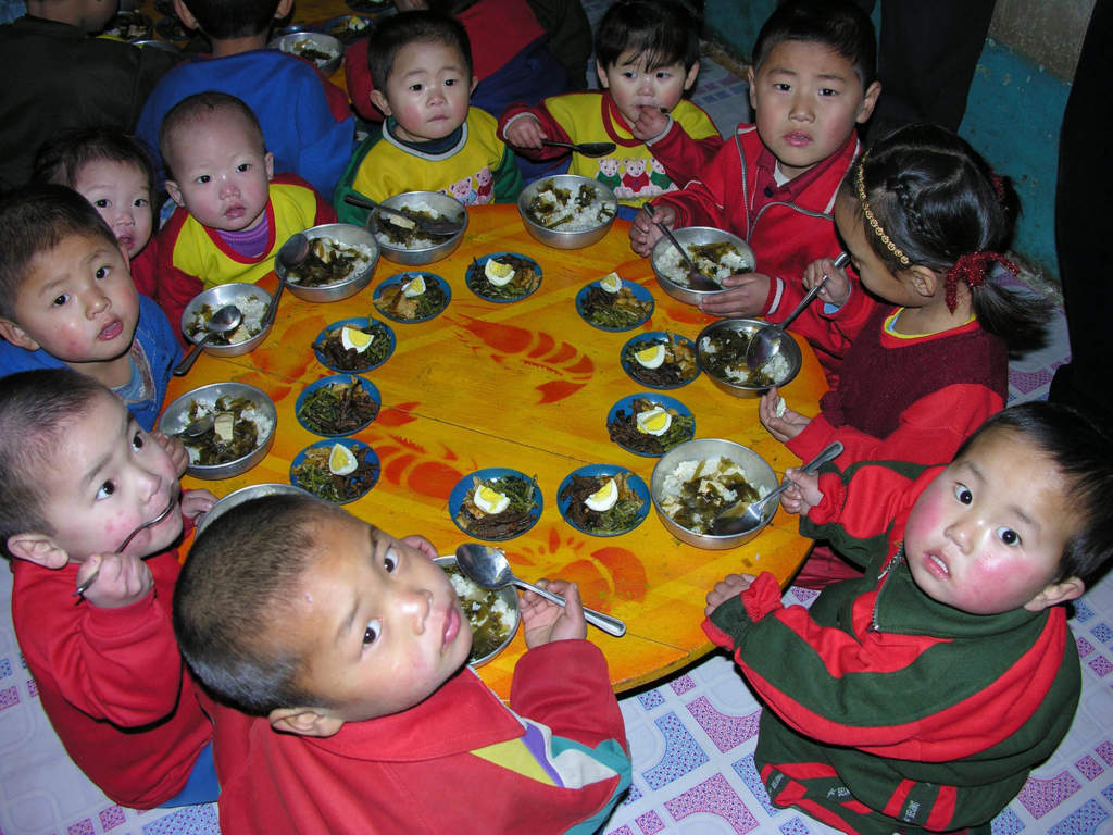 In this photo released by the World Food Program, North Korean children eat a lunch, including rice provided by the U.N. World Food Programme, at a nursery in Yomju county, North Pyongan province, North Korea, Feb. 21, 2005. Malnutrition among North Korean children has fallen, but more than a third still don't have enough food and the country needs substantial aid to get through 2005, U.N. agencies said Monday, March 7, 2005. The number of malnourished or stunted North Korean children under 6 has dropped to 37 percent, compared with 42 percent in 2002, according to a survey by the World Food Program and UNICEF. It found that children with acute malnutrition fell from 9 percent to 7 percent. (AP Photo/World Food Program, Gerald Bourke) COPYRIGHT SCANPIX SWEDEN Code: 436
