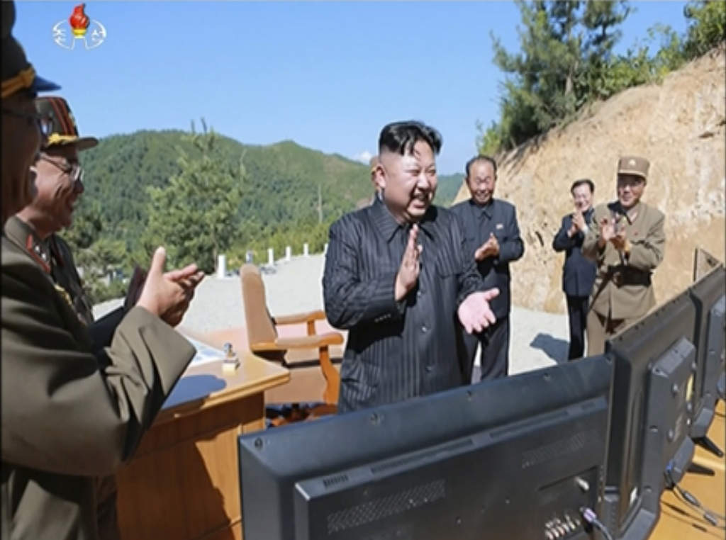 Bild från ett nyhetsinslag den 4 juli 2017 visar Kim Jong-Un applådera efter uppskjutningen av en Hwasong-14-robot. Foto: KRT/AP